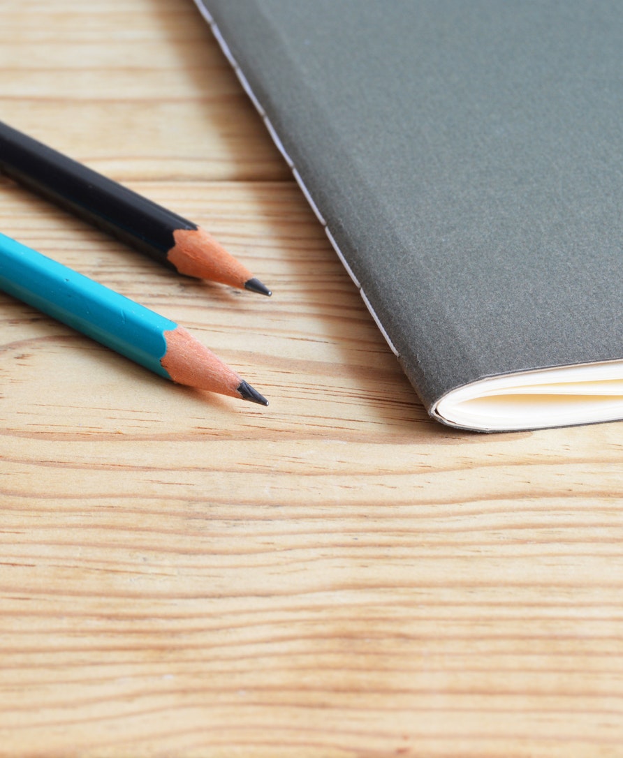business composition book on a brown desk